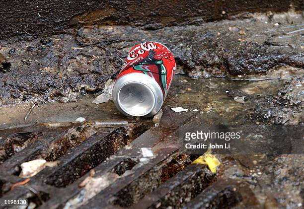 Cola can lies in a gutter behind restaurants August 1, 2002 in central London. The "Keep Britain Tidy" campaign has warned that the rat population...
