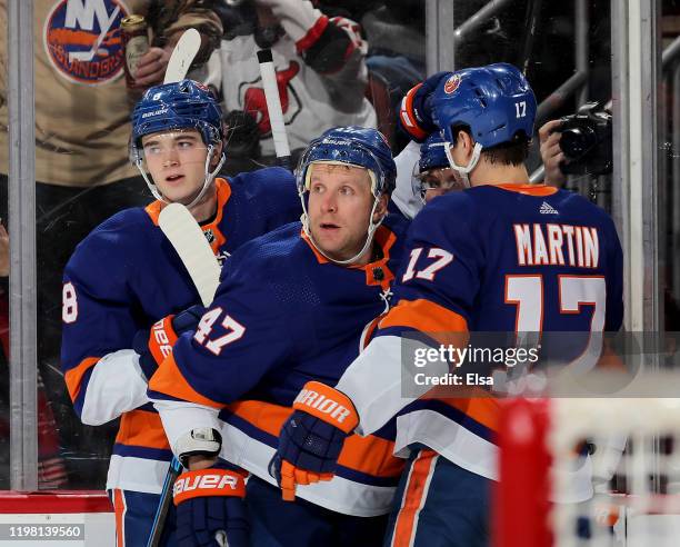 Noah Dobson,Leo Komarov and Matt Martin of the New York Islanders congratulate teammate Casey Cizikas after he scored a goal in the first period...