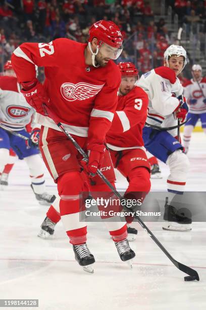 Brian Lashoff of the Detroit Red Wings tries to control the puck while playing the Montreal Canadiens during the first period at Little Caesars Arena...