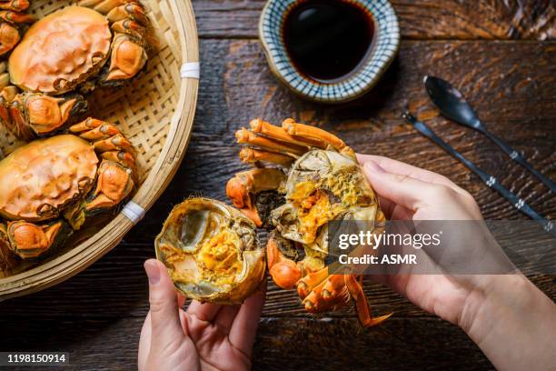 crabs on the wooden table - crab leg stock pictures, royalty-free photos & images