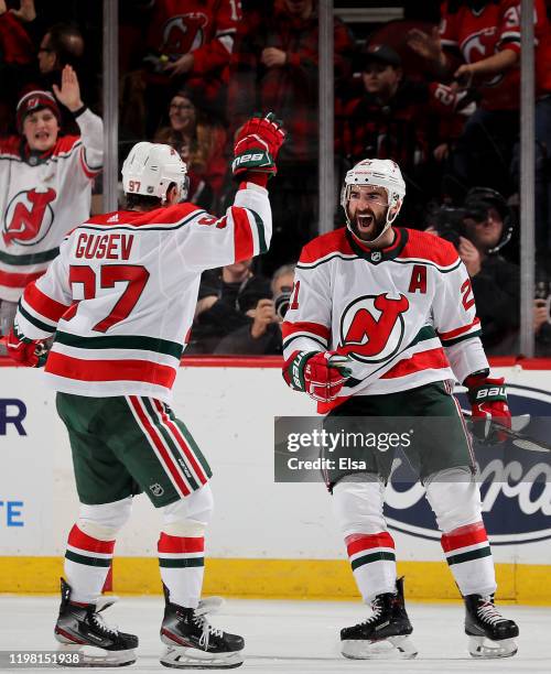 Kyle Palmieri of the New Jersey Devils celebrates his goal with teammate Nikita Gusev in the third period against the New York Islanders at...