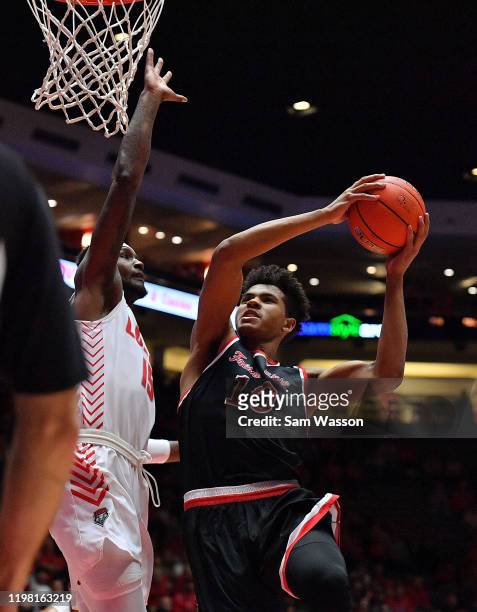 Orlando Robinson of the Fresno State Bulldogs shoots against Carlton Bragg Jr. #15 of the New Mexico Lobos during their game at Dreamstyle Arena -...