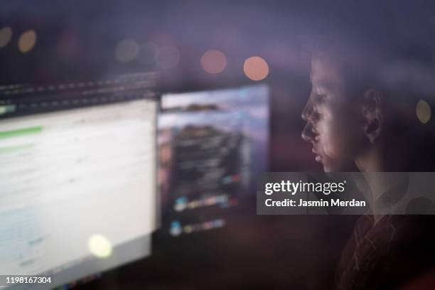 teenage boy working on computer at night - online bullying fotografías e imágenes de stock