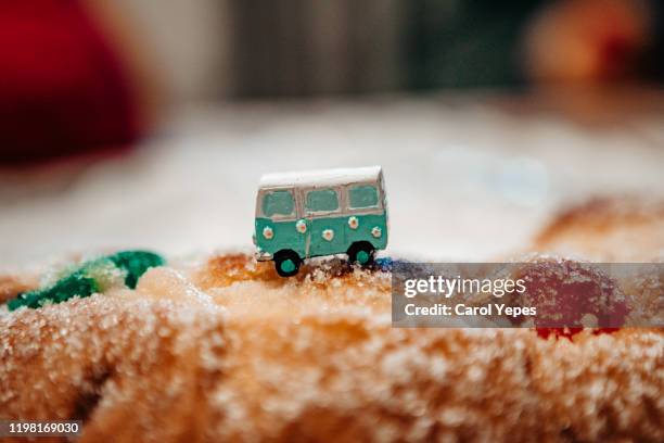 van figurine taveling by sugar cake - rosca de reyes stock pictures, royalty-free photos & images