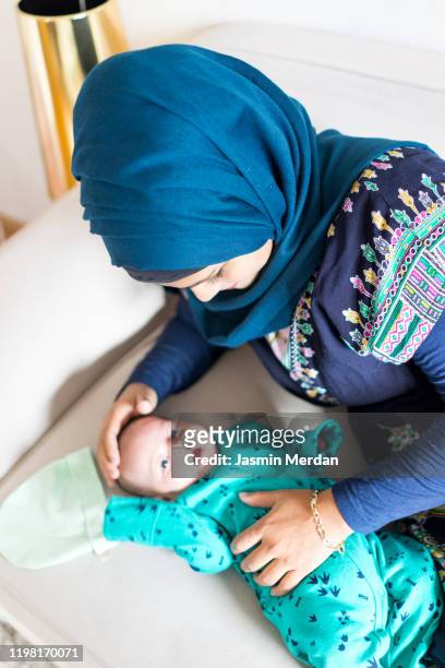 muslim mother and baby - arabian baby stock-fotos und bilder
