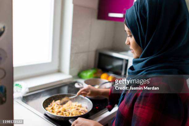 young east asian woman making breakfast - daily life in bangladesh stock pictures, royalty-free photos & images