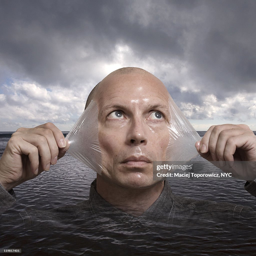 Man with peeling skin emerges from water