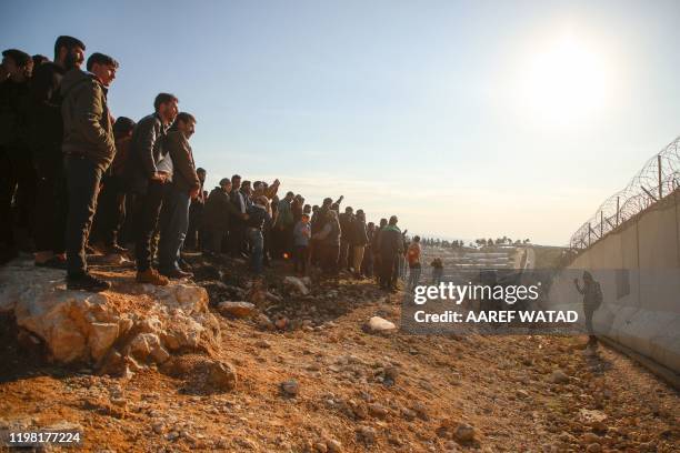 Syrians gather during a symbolic protest in the city of Harem in the rebel-held northern countryside of Syria's Idlib on the border with Turkey on...