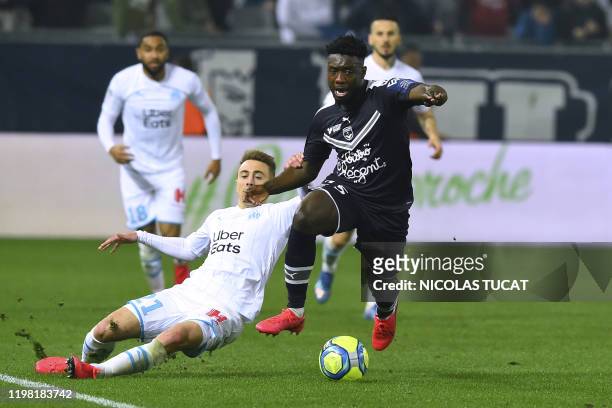 Marseille's French midfielder Valentin Rongier vies with Bordeaux's French defender Enock Kwateng during the French L1 football match between...