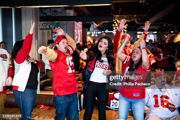 Fans react as they watch the San Francisco 49ers play the Kansas City Chiefs during a Super Bowl LIV watch party at SPIN San Francisco on February 2,...