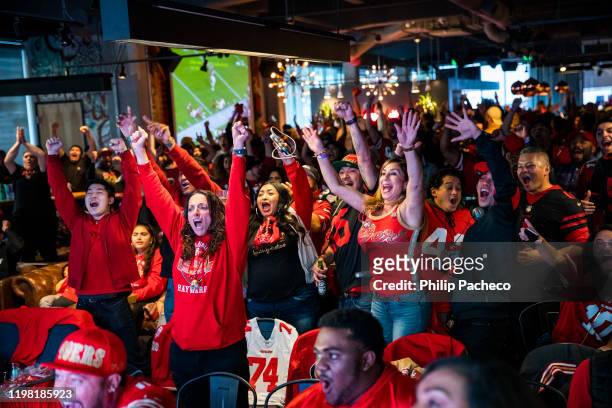 Fans react as they watch the San Francisco 49ers play the Kansas City Chiefs during a Super Bowl LIV watch party at SPIN San Francisco on February 2,...