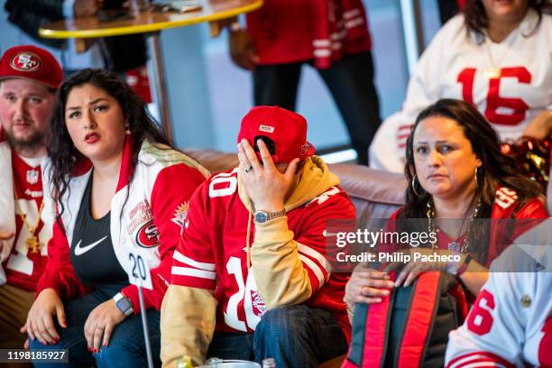 Fans watch the San Francisco 49ers play the Kansas City Chiefs during a Super Bowl LIV watch party at SPIN San Francisco on February 2, 2020 in San...