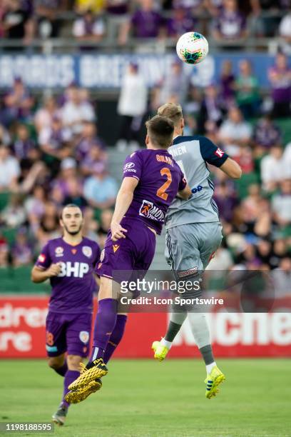 Perth Glory Defender Alex Grant and Melbourne Victory Forward Nils Ola Toivonen go for the ball during the round 17 A-League soccer match between...