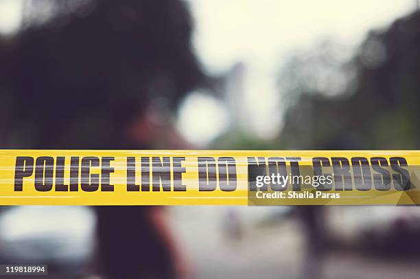 yellow police tape - absperrband stock-fotos und bilder