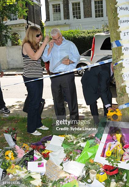 Amy Winehouse's father Mitch Winehouse is seen looking at the floral tributes outside her Camden Square home on July 25, 2011 in London, England.