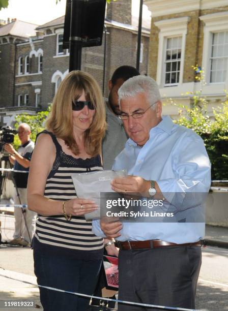 Amy Winehouse's father Mitch Winehouse is seen looking at the floral tributes outside her Camden Square home on July 25, 2011 in London, England.