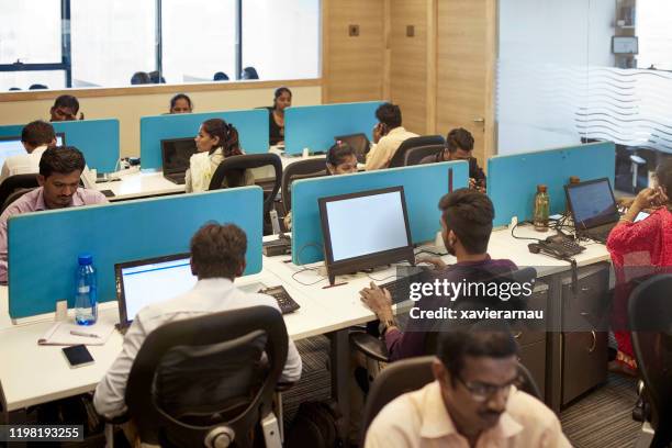 indian office workers sitting in front of their computers - women india partition stock pictures, royalty-free photos & images