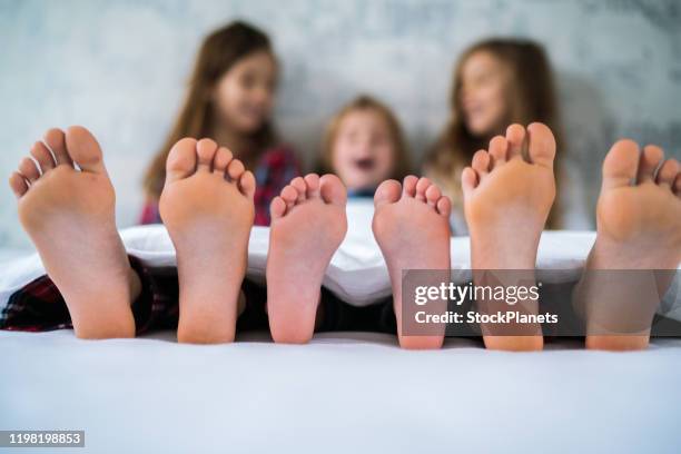 kids in bed - feet girl stock pictures, royalty-free photos & images