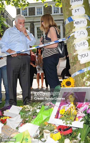 Amy Winehouse's father Mitch Winehouse is seen looking at floral tributes left outside her Camden Square home on July 25, 2011 in London, England.