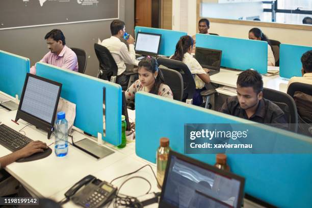 focused indian office workers sitting at computers - women india partition stock pictures, royalty-free photos & images