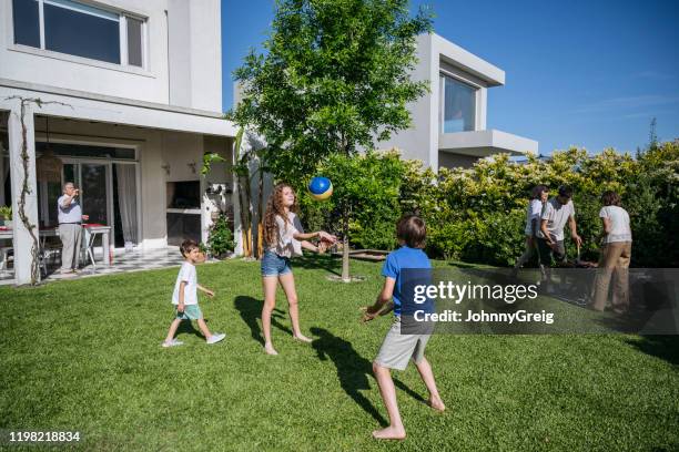 buenos aires family barbecuing and relaxing in backyard - backyard barbeque stock pictures, royalty-free photos & images