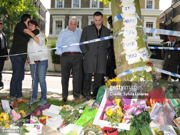 Amy Winehouse's brother Alex Winehouse, mother Janis Winehouse, father Mitch Winehouse and ex boyfriend Reg Traviss are seen looking at floral...