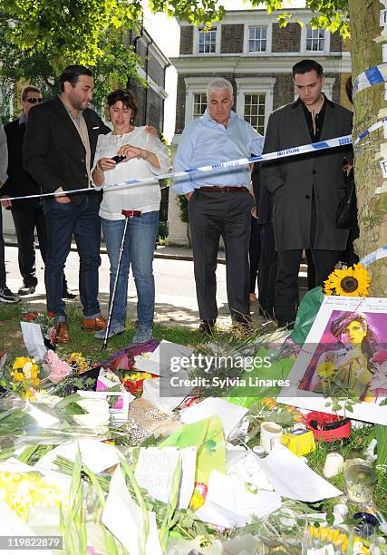 Amy Winehouse's brother Alex Winehouse, mother Janis Winehouse, father Mitch Winehouse and ex boyfriend Reg Traviss are seen looking at floral...