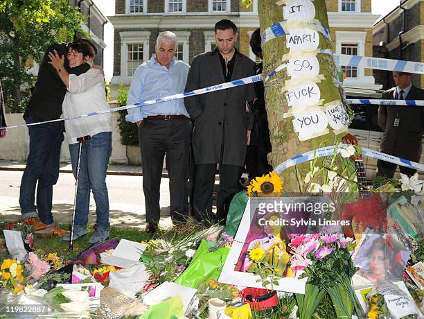 Amy Winehouse's brother Alex Winehouse, mother Janis Winehouse, father Mitch Winehouse and ex boyfriend Reg Traviss are seen looking at floral...