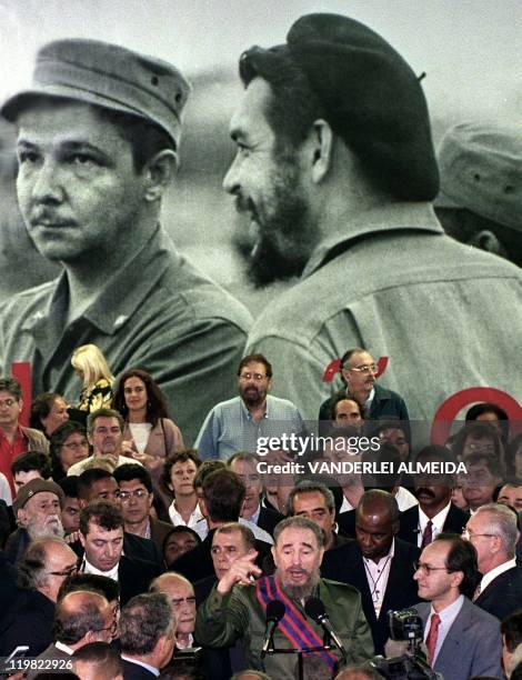 Cuban president Fidel Castro gives a speech 30 June in front of a photo mural in homage to his brother Raul and Che Guevara next to Brazilian...