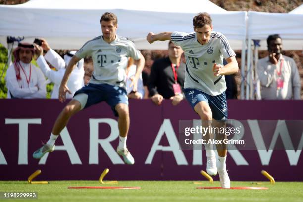 Leon Goretzka and Thomas Mueller exercise during day five of the FC Bayern Muenchen winter training camp at Aspire Academy on January 08, 2020 in...