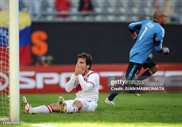 Peruvian defender Renzo Revoredo gestures after missing a goal near Venezuelan goalkeeper Renny Vega during the 2011 Copa America football tournament...