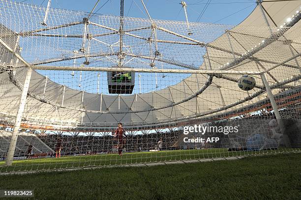 Venezuelan goalkeeper Renny Vega falls to the ground after being scored on by Peruvian forward William Chiroque during the 2011 Copa America football...