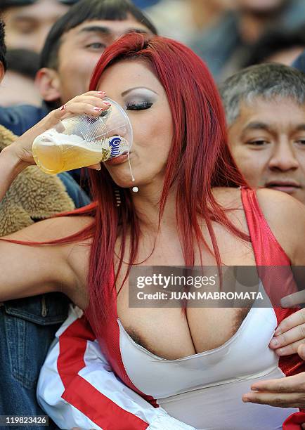 Peruvian supporter drinks a beer during the 2011 Copa America football tournament third-place match against Venezuela held at the Ciudad de La Plata...