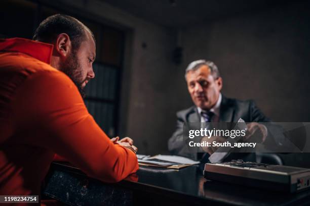 man detective and prisoner in interrogation room - probation stock pictures, royalty-free photos & images