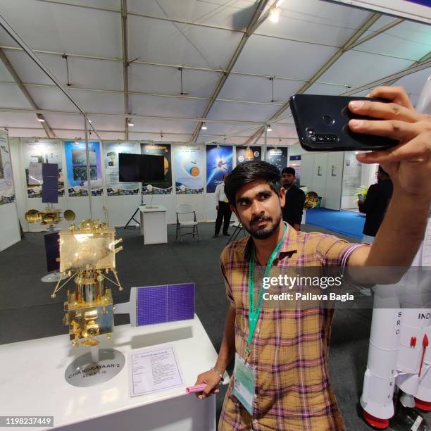 January 4: A man takes selfie with a scale model made of brass of the second Indian mission to the moon Chandrayaan-2 on display at a stall at the...