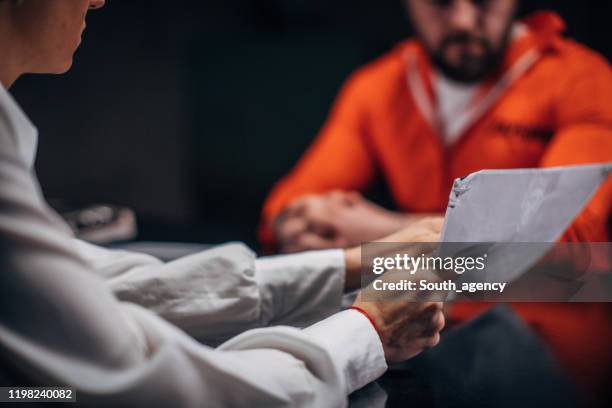 woman detective interrogating a prisoner in interrogation room - probation stock pictures, royalty-free photos & images