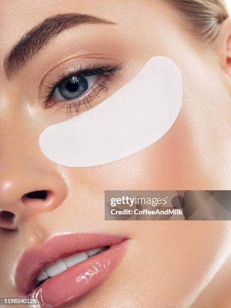 woman with eye patches under her eyes - eye patch stock pictures, royalty-free photos & images