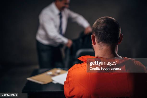 man detective and prisoner in interrogation room - probation stock pictures, royalty-free photos & images