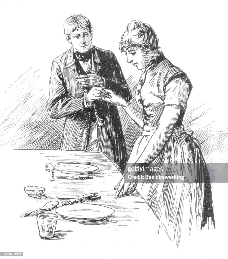 Young couple holding hand while she sets the table