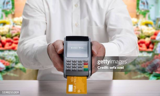 credit card purchase with pin entry at the greengrocer's shop - entering pin stock pictures, royalty-free photos & images
