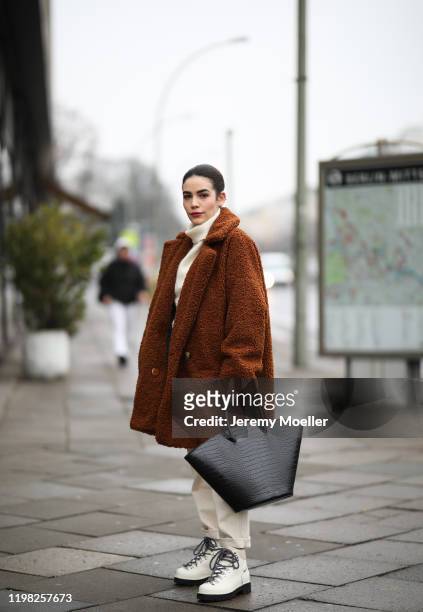Frankie Miles wearing Proenza shoes, Wrangler jeans and Gestuz coat on January 07, 2020 in Berlin, Germany.