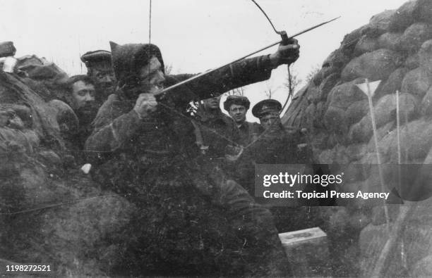 British soldier using a bow and arrow to send a message from a trench during World War I, April 1915.