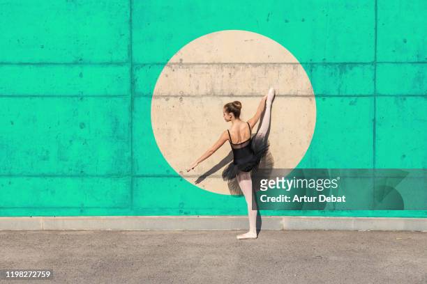 creative picture of ballerina stands out from circle with color wall. - classic round one stock pictures, royalty-free photos & images