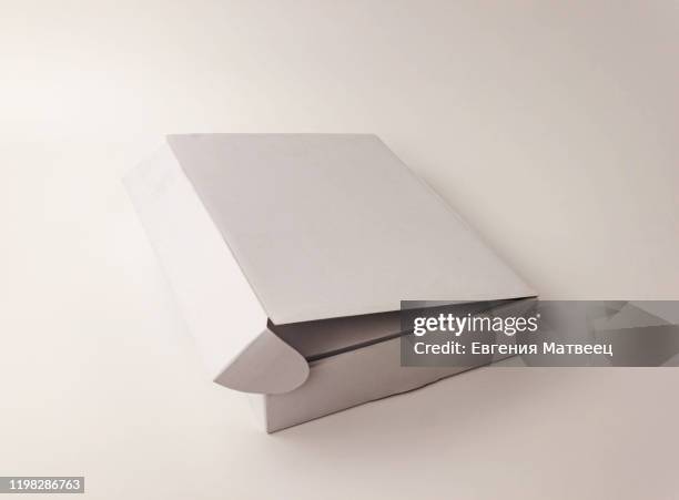 one white flat kraft paper box on light background. packing, transportation, moving concept - box white flat stock-fotos und bilder