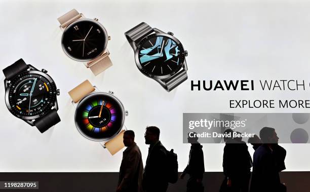 Attendees walk by the Huawei booth during CES 2020 at the Las Vegas Convention Center on January 8, 2020 in Las Vegas, Nevada. CES, the world's...