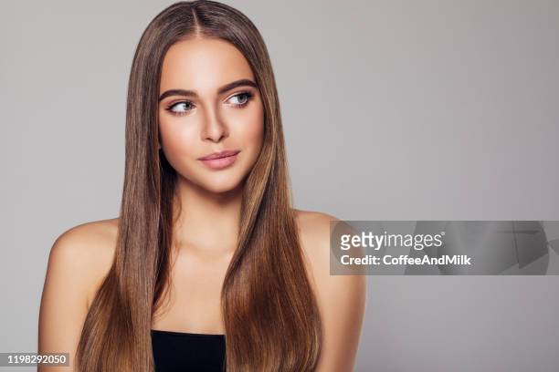 young woman with beautiful brown hairstyle - long hair stock pictures, royalty-free photos & images