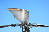 Close-up helicopter rotor with clear sky background