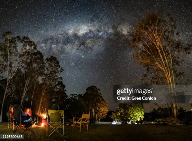 camping under the milky way with a lovely campfire in rural australia. - eco tourism stock pictures, royalty-free photos & images