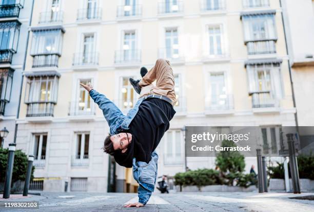 hip hop dancer man jumping in the city of madrid spain. - breakdancing stock pictures, royalty-free photos & images