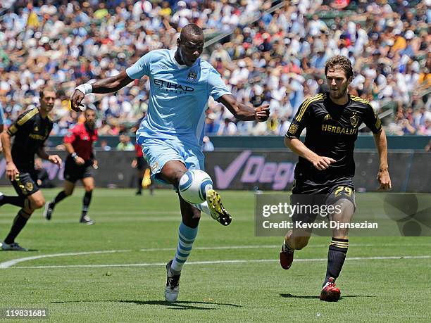 Mario Balotelli of Manchester City attempts a shot on goal against Kyle Davies Los Angeles during the Herbalife World Football Challenge 2011 at the...